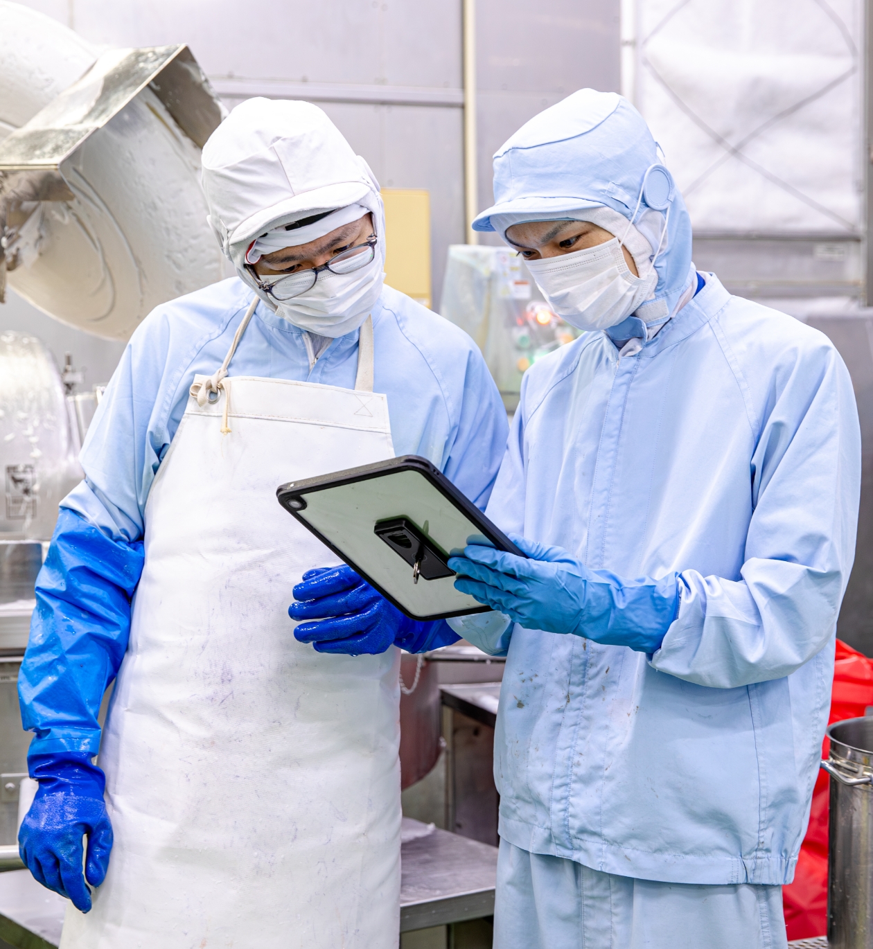 タブレットを見て打ち合わせをする作業員